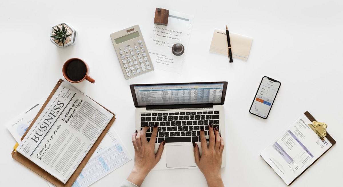 Cuaderno contable, gráficos y calculadora sobre una mesa